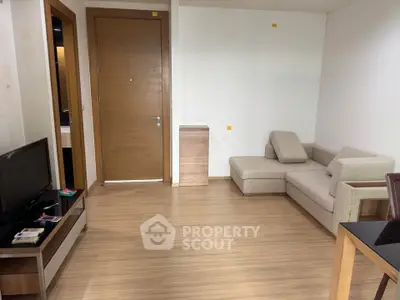 Modern living room with wooden flooring and cozy beige sofa