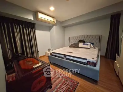 Cozy bedroom with modern furniture and air conditioning, perfect for relaxation.