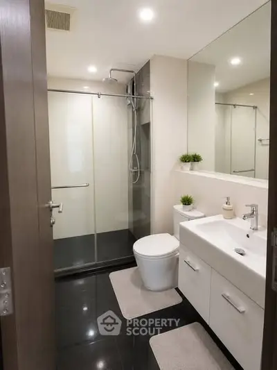 Modern bathroom with sleek fixtures and glass shower enclosure