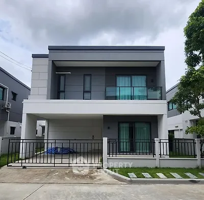 Modern two-story house with sleek design and spacious driveway
