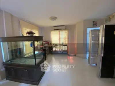 Spacious room with large aquarium and modern appliances