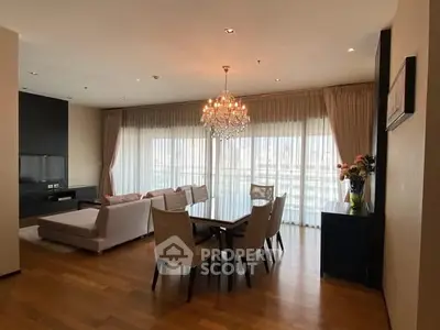 Elegant living room with chandelier and large windows in modern apartment