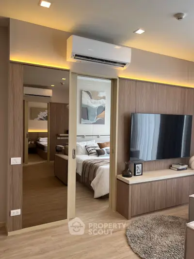 Modern living room with sleek design and cozy bedroom view