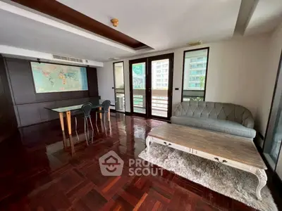 Spacious living room with elegant decor and large windows offering natural light