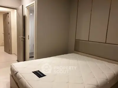 Modern bedroom with minimalist design and comfortable mattress in a stylish apartment.