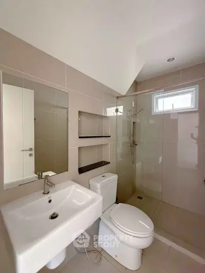Modern bathroom with sleek fixtures and neutral tiles