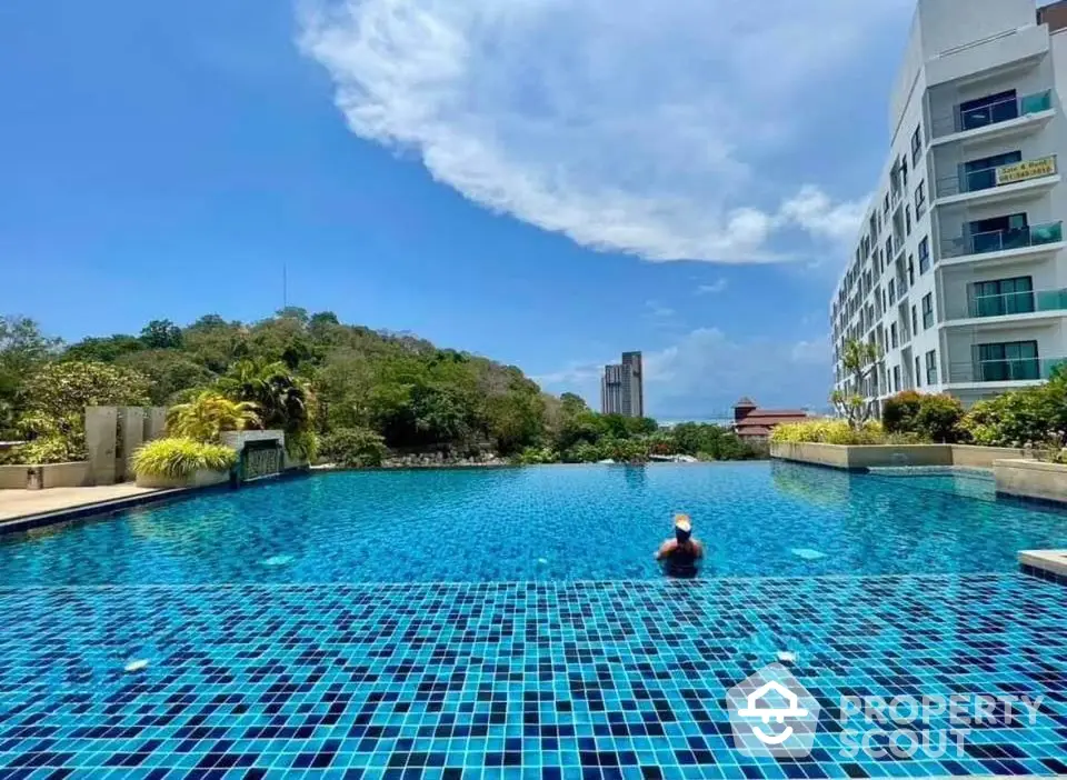 Luxurious apartment complex with stunning infinity pool and scenic views.