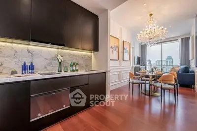 Luxurious open kitchen and dining area with elegant chandelier and city view.