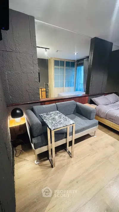 Modern studio apartment with cozy living area and stylish decor