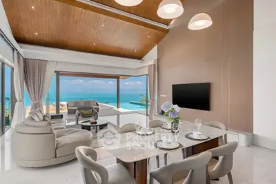 Luxurious living room with ocean view, high ceilings, and elegant decor in a modern beachfront property.