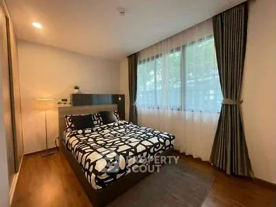 Modern bedroom with stylish decor and large window for natural light