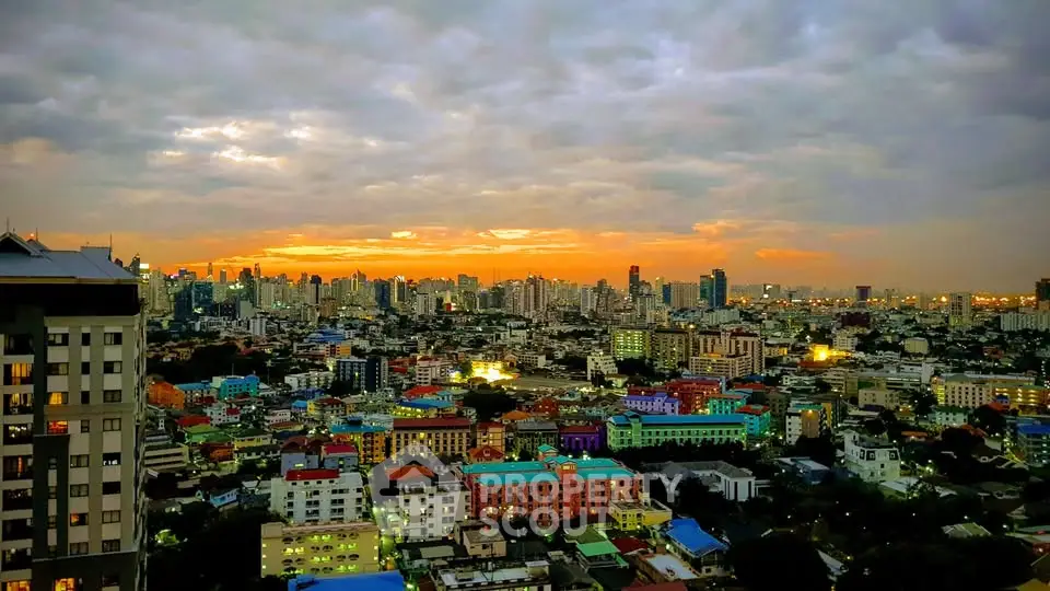 Stunning cityscape view at sunset with vibrant skyline and colorful buildings.
