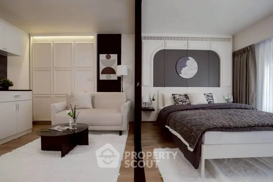 Modern studio apartment with stylish living area and cozy bedroom, featuring elegant decor and natural light.