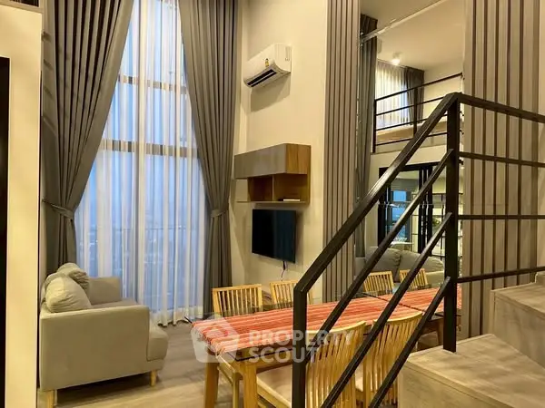 Modern duplex living room with high ceilings and elegant decor