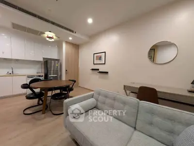 Modern open-plan living room with sleek kitchen and stylish furniture