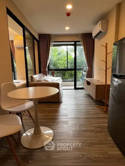 Modern living room with large windows and stylish furniture, perfect for relaxation.