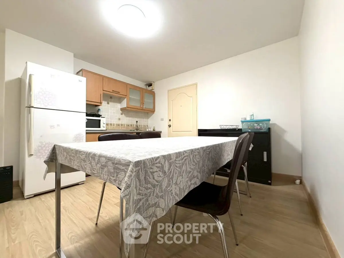 Spacious kitchen with dining area, featuring modern appliances and ample natural light.