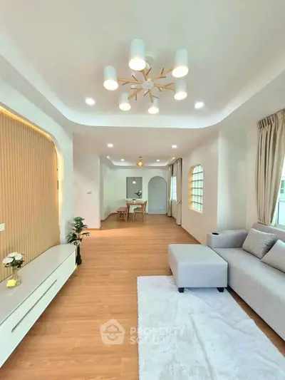 Spacious modern living room with elegant lighting and cozy seating area