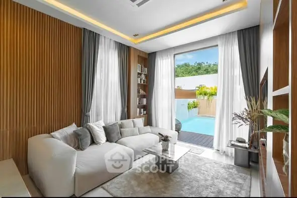 Luxurious living room with pool view, modern decor, and elegant furnishings.