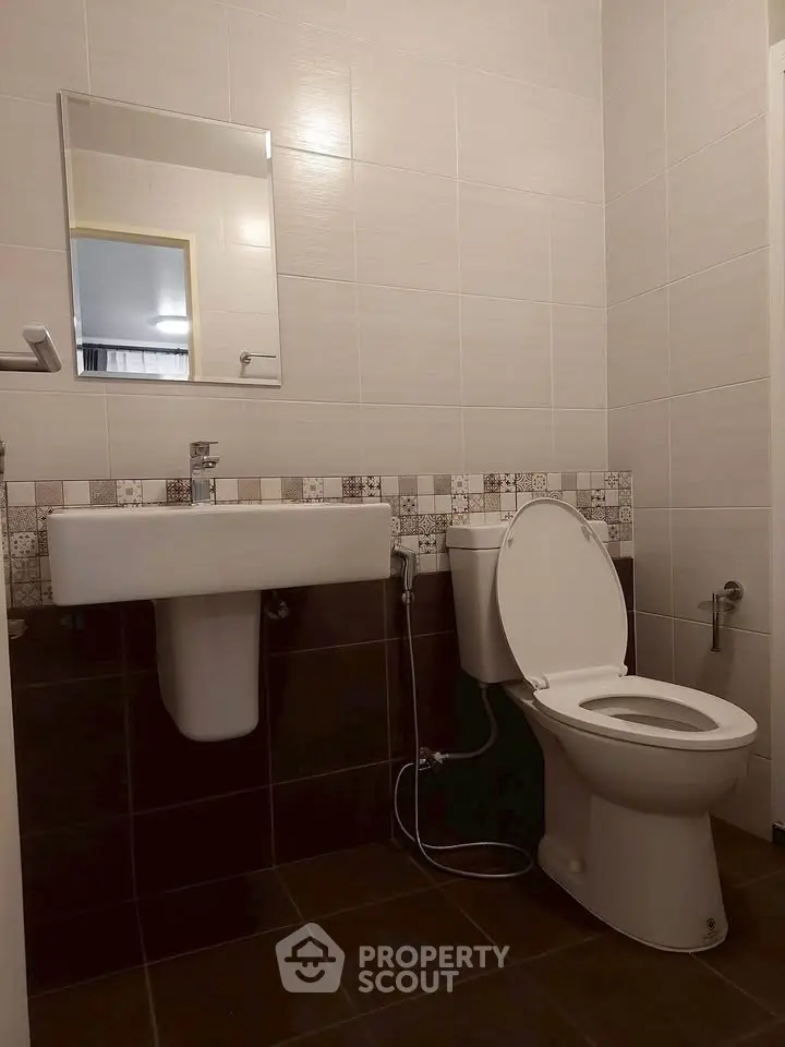 Modern bathroom with sleek fixtures and stylish tile design, perfect for a contemporary home.