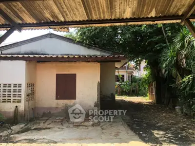 Charming rustic house with spacious outdoor area and lush greenery, perfect for renovation or development.