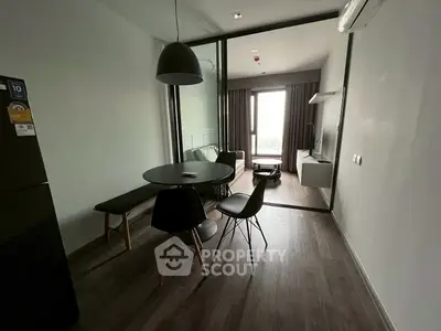 Modern dining area with sleek furniture and natural light in a contemporary apartment.