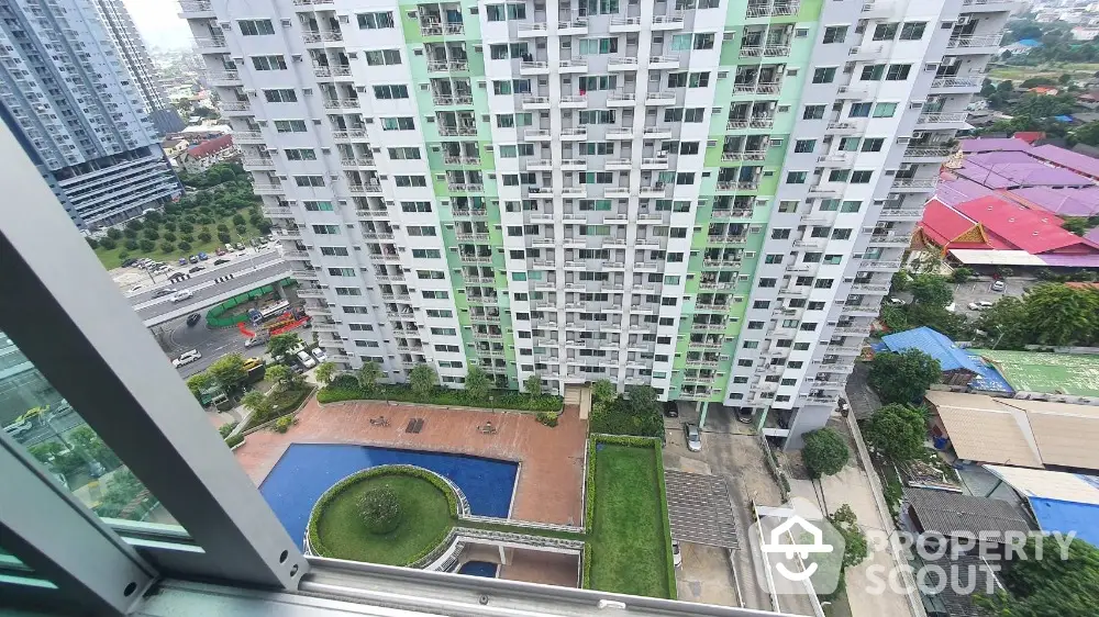 High-rise apartment building with pool and garden view from balcony