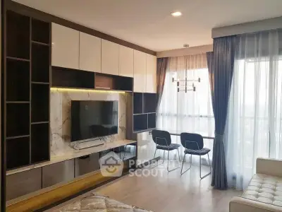 Modern living room with stylish TV unit and large windows for natural light.