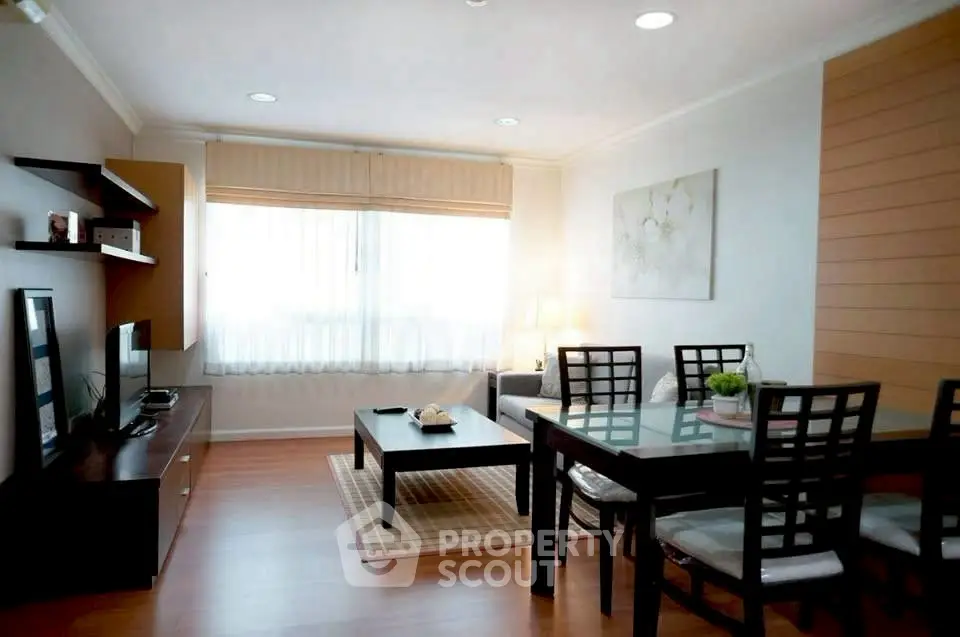 Spacious and modern living room with elegant dining area and natural light.