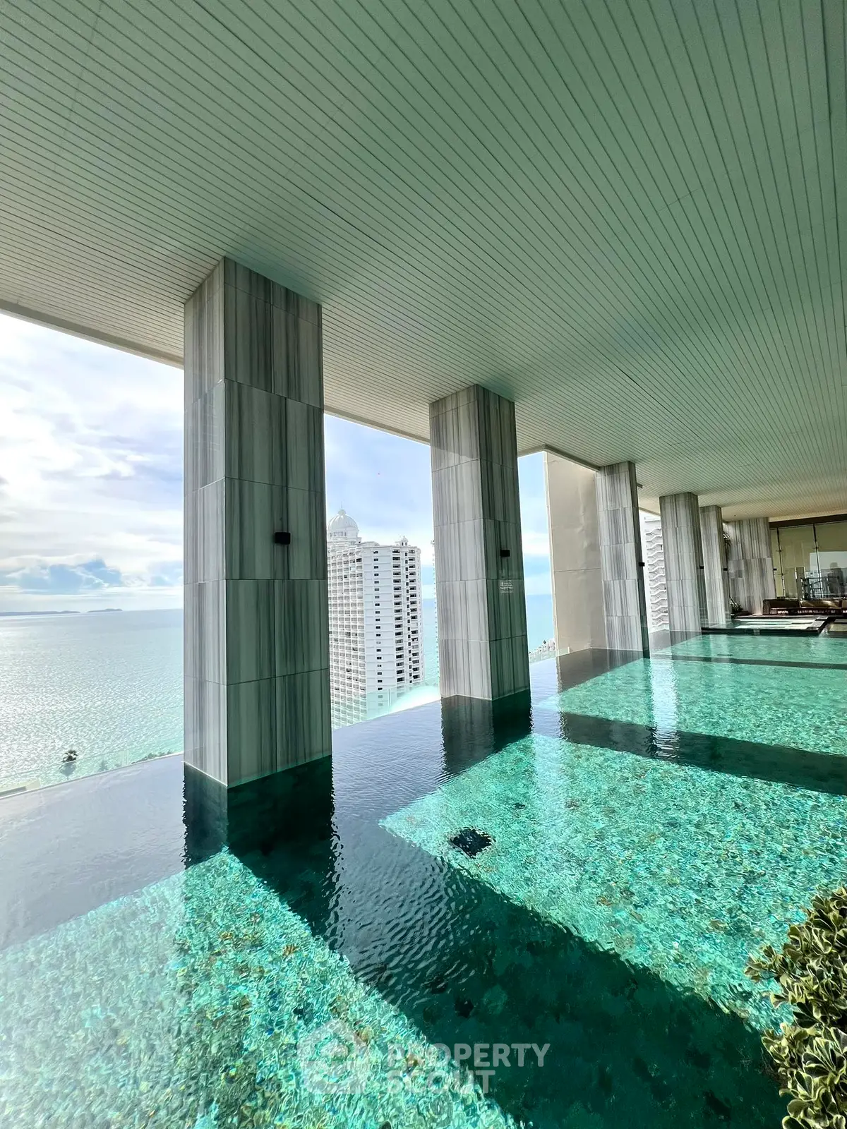 Luxurious rooftop infinity pool with stunning ocean view in high-rise building