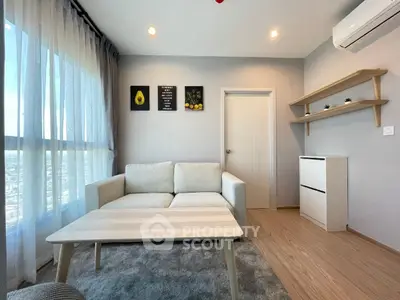 Modern living room with cozy sofa, stylish decor, and natural light from large windows.