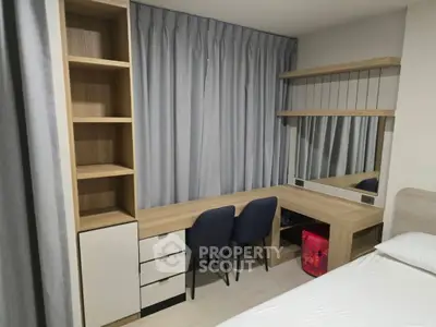 Modern bedroom with stylish desk and ample storage space