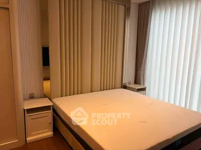 Luxurious bedroom with elegant design and ample natural light, featuring a comfortable bed and stylish decor.