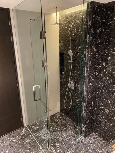 Luxurious modern bathroom with elegant glass shower enclosure and marble tiles