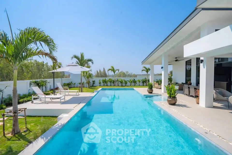 Luxurious modern villa with stunning pool and lush garden view