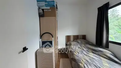 Cozy bedroom with natural light and compact storage solutions
