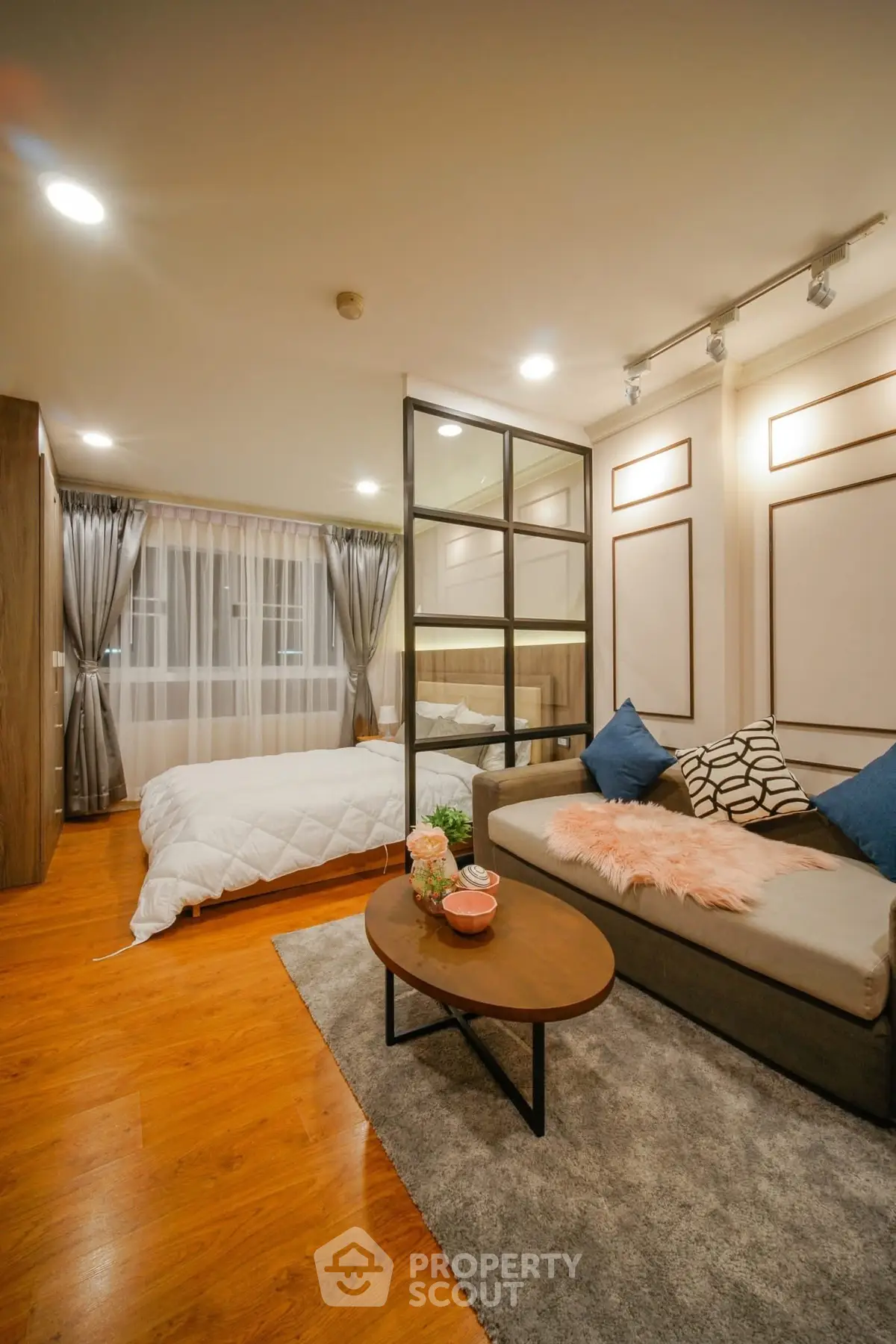 Modern studio apartment with cozy living area and stylish bedroom