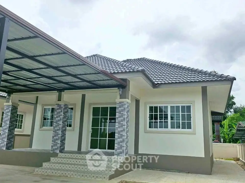 Charming single-story home with modern exterior and covered carport, perfect for family living.
