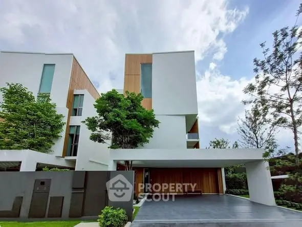 Modern architectural masterpiece with sleek design and lush greenery, perfect for luxury living.