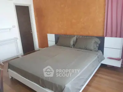 Modern bedroom with stylish decor and wooden flooring in a cozy apartment.