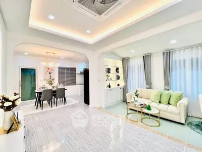 Elegant open-plan living and dining area with modern decor and ambient lighting.