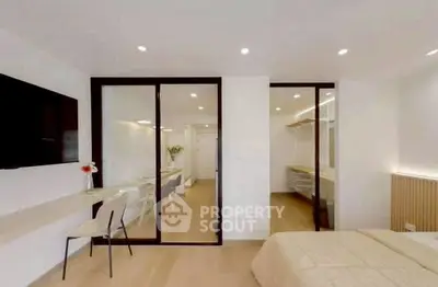 Modern bedroom with sliding glass doors and minimalist decor