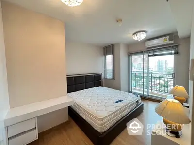 Spacious bedroom with city view and modern furnishings in high-rise apartment