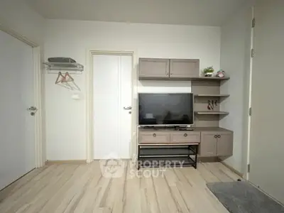 Modern living room with sleek TV stand and wooden flooring