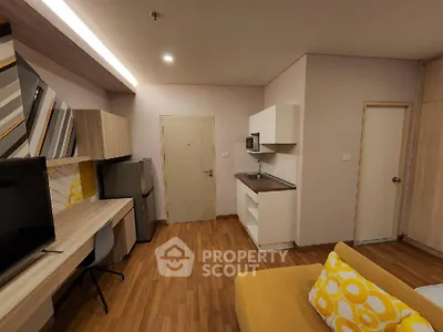 Modern studio apartment with stylish decor and compact kitchen