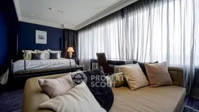 Luxurious bedroom with elegant decor and large windows offering natural light.