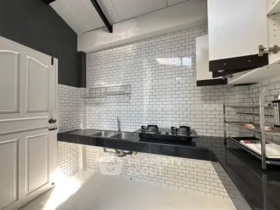 Modern kitchen with sleek gas stove and white subway tiles