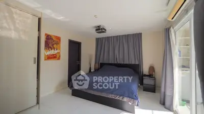 Spacious bedroom with modern decor and natural light