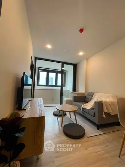 Modern living room with cozy sofa and stylish decor in a contemporary apartment.