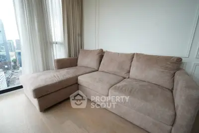 Spacious living room with plush sectional sofa and city view
